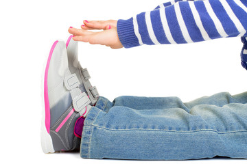 Fototapeta na wymiar Young girl touching shoe while exercising