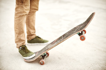 Fototapeta na wymiar Close-up of skateboarders foot while skating in skate park