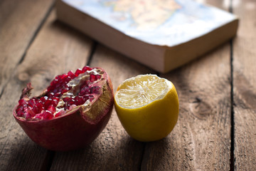 Garnet fruit near the book