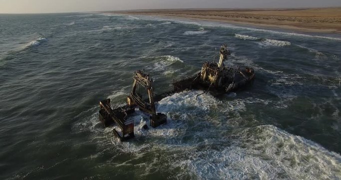 4K aerial drone video view of Namibian Atlantic coastline, Zeila L-758  Walvis Bay shipwreck and sand beach, Skeleton Coast Park landscape with ocean background at Namibia's west coast