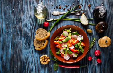 Obraz na płótnie Canvas Vegetarian salad on rustic wooden background