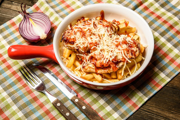 Baked French fries with chicken breasts