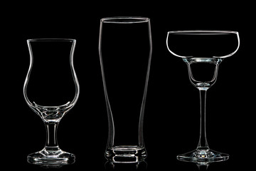 Silhouette of different glasses on black background