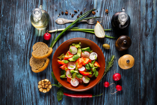 Vegetarian salad on rustic wooden background