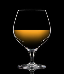 Silhouette of colorful whiskey glass with on black background