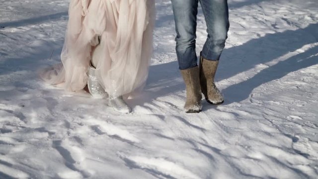 Man and woman walking in a park at winter sunny day