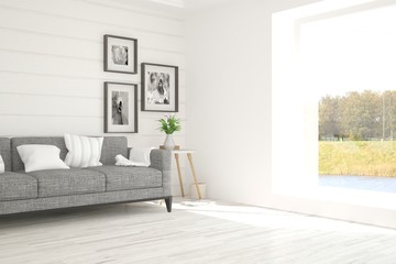 White room with sofa and green landscape in window. Scandinavian interior design. 3D illustration