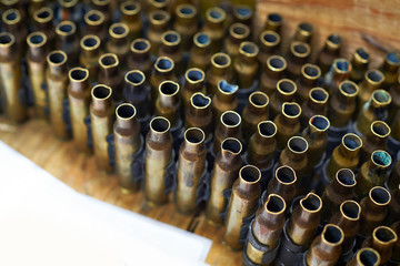 Brass cases of cartridges in machine-gun tape
