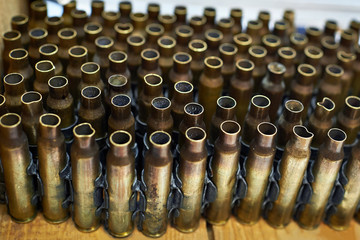 Brass cases of cartridges in machine-gun tape