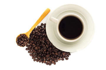A cup of coffee and coffee beans in wooden spoon isolated on white background.