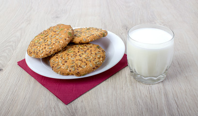 Biscuits with cereals, a glass of milk, breakfast.