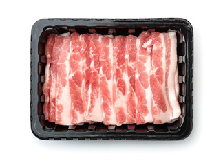 Top view of plastic disposable tray with raw sliced bacon