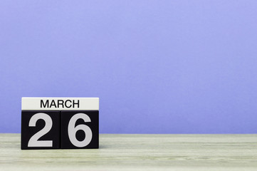 March 26th. Day 26 of month, calendar on table with purple background. Spring time, empty space for...