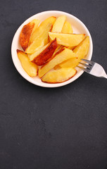 Baked potatoes on a black background