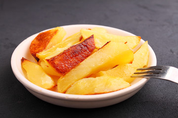 Baked potatoes on a black background