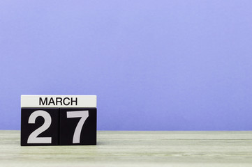 March 27th. Day 27 of month, calendar on table with purple background. Spring time, empty space for text. World Theatre Days