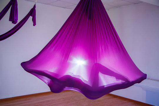 Silhouette of a woman using hammock.