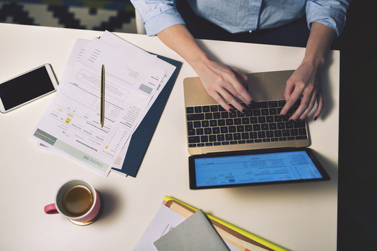 Overhead view of businesswoman using laptop in office