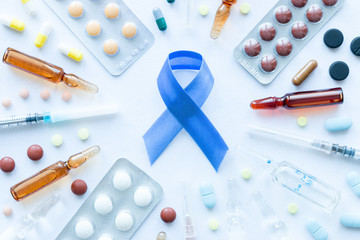 blue ribbon symbol of prostate cancer, syringes and pills