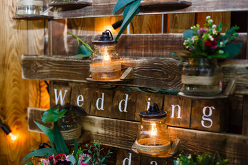 The white wooden word Wedding on a wooden background. A wedding decor