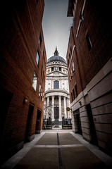 The prospect of the Cathedral of Saint Paul through a narrow alley that faces the rear of the main facade