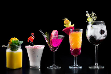 modern rustic selection of cocktails drinks alcohol at bar counter with defocused background various colours glass