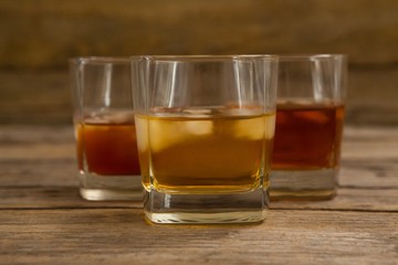 Three glasses of whiskey with ice cube