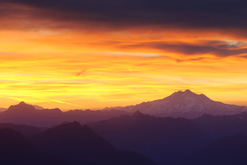 Silhouette mountains against dramatic sky during sunset
