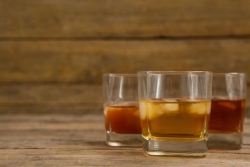 Three glasses of whiskey with ice cube