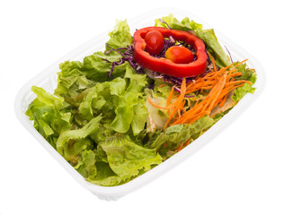 Salad in plastic container isolated on white background
