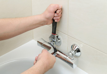 Installing faucet with thermostat.