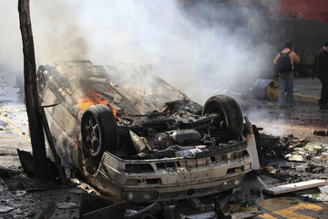 Car overturned and burned
Street damage caused during a student strike in Santiago's Downtown,...