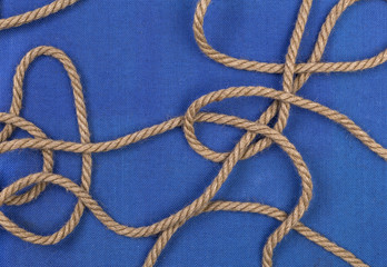 Ship rope on blue background, top view with copy space