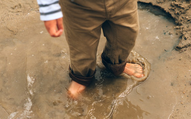 A boy hiking through water