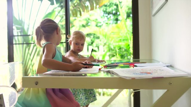Two little sisters draw at home 4K