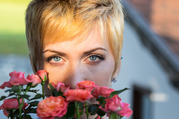 real woman smelling flowers outdoors