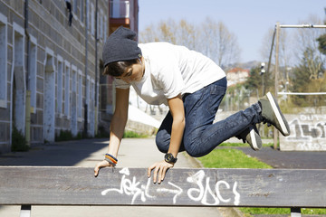 child in the park outside, playing, parkour