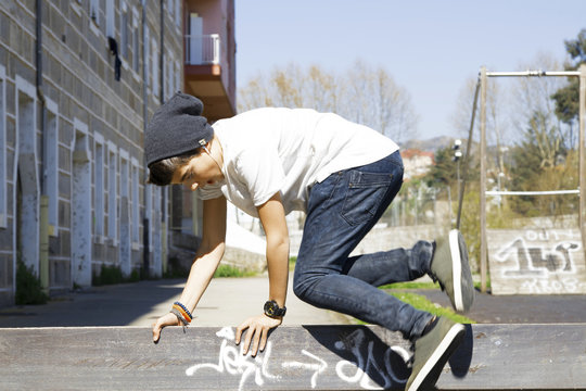 child in the park outside, playing, parkour