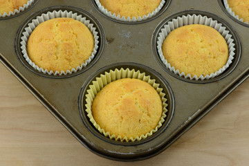 Close up of freshly baked cornbread muffins in muffin pan