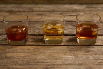 Three glasses of whiskey with ice cube
