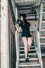 Portrait of girl in sexy uniform policewoman with gun bag full of money 100 dollar Cute woman with...