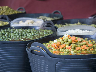 Variety olives in a plastic basket in a market
