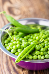 Raw organic green peas in  bowl