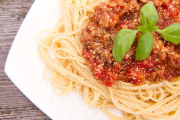 Spaghetti bolognese on a wooden background