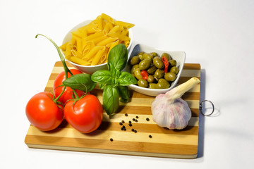 Pasta ingredients, tomato garlic olives and basil