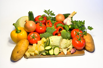 Fototapeta na wymiar Raw vegetables, pepper tomato cabbage onion potatoes garlic basil zucchini