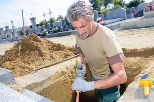 man digging a grave