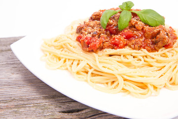 Spaghetti bolognese on a wooden background