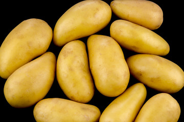 Small Organic Potatoes on a Black Background