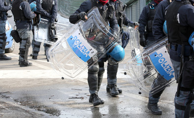 police with shields and riot gear during the sporting event